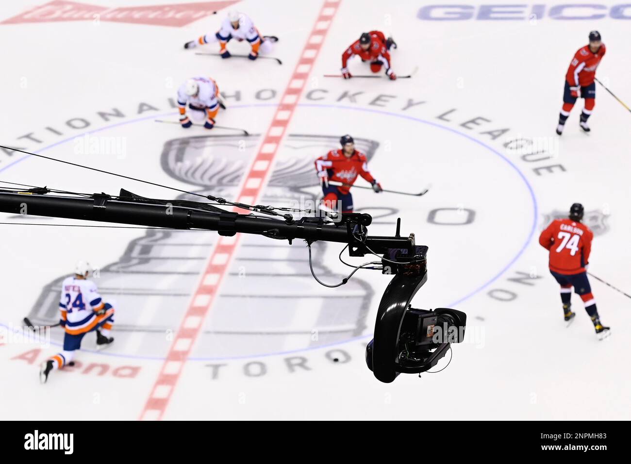 A high-angle television camera is viewed as New York Islanders and Washington Capitals players warm up prior to NHL Eastern Conference Stanley Cup playoff hockey action in Toronto, Friday, Aug