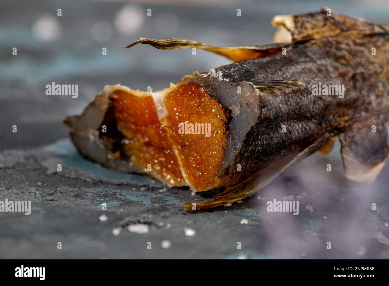 Salted dried goby fish with caviar. Fish appetizer for beer. Stockfish Stock Photo