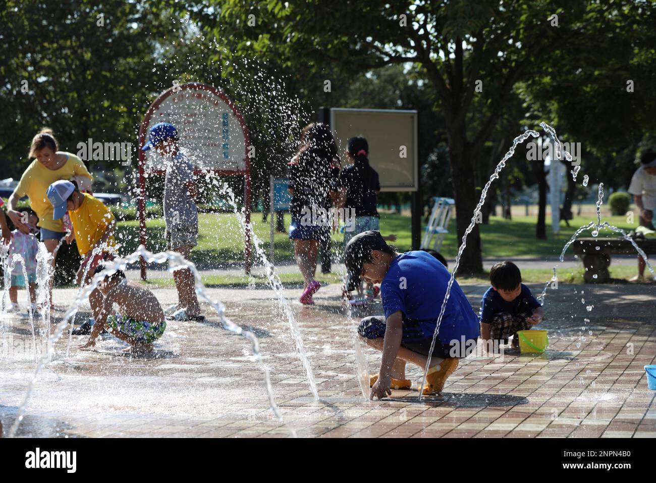 Kids splash fountain water at a water park in Isesaki, Gunma Prefecture