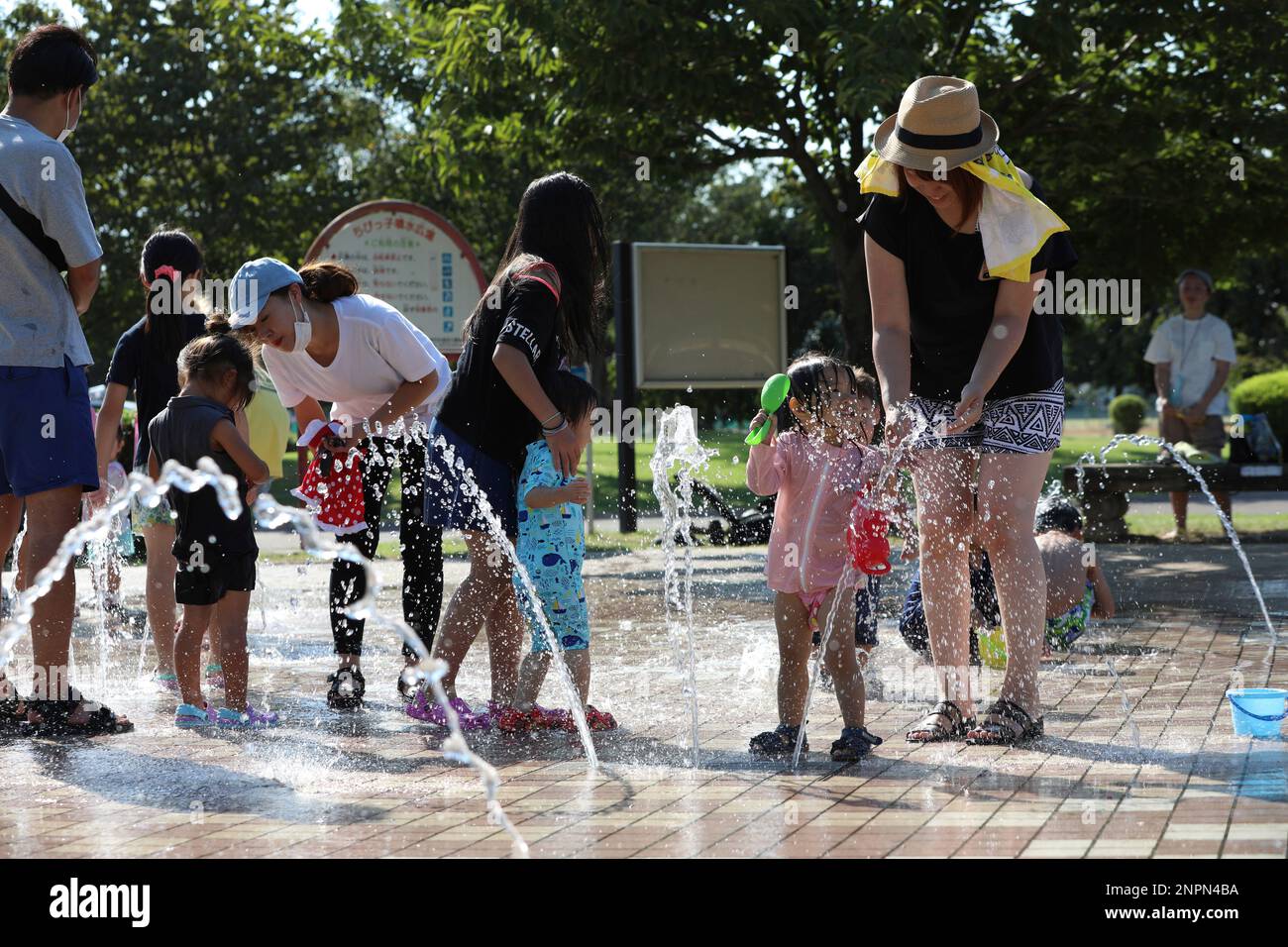 Kids splash fountain water at a water park in Isesaki, Gunma Prefecture