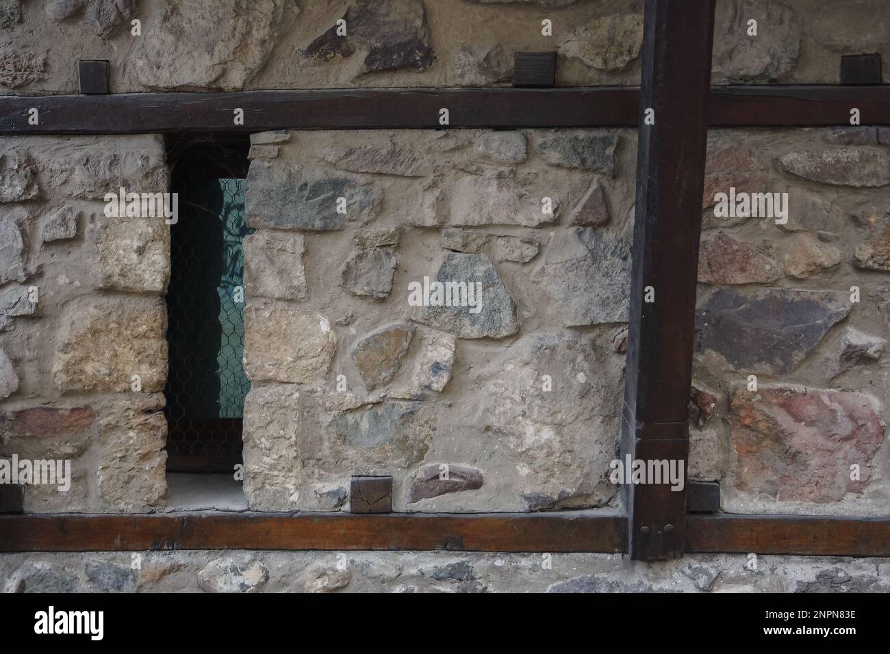 medieval windows on the stone wall. traditional old balkan architecture Stock Photo