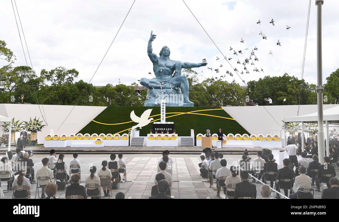 Doves fly over the Statue of Peace during a ceremony at Nagasaki Peace