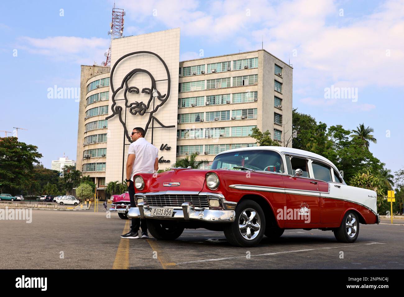 Vintage classic car Chevrolet on Revolution Square against building of Ministries of Information and Communications with Camilo Cienfuegos portrait Stock Photo