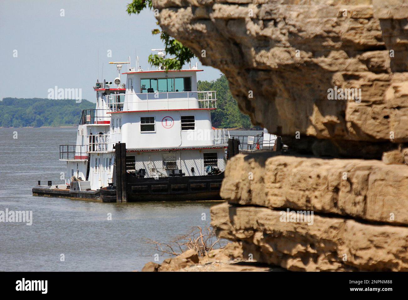 The famous CaveInRock Ferry is seen behind the famous rocks of Cave