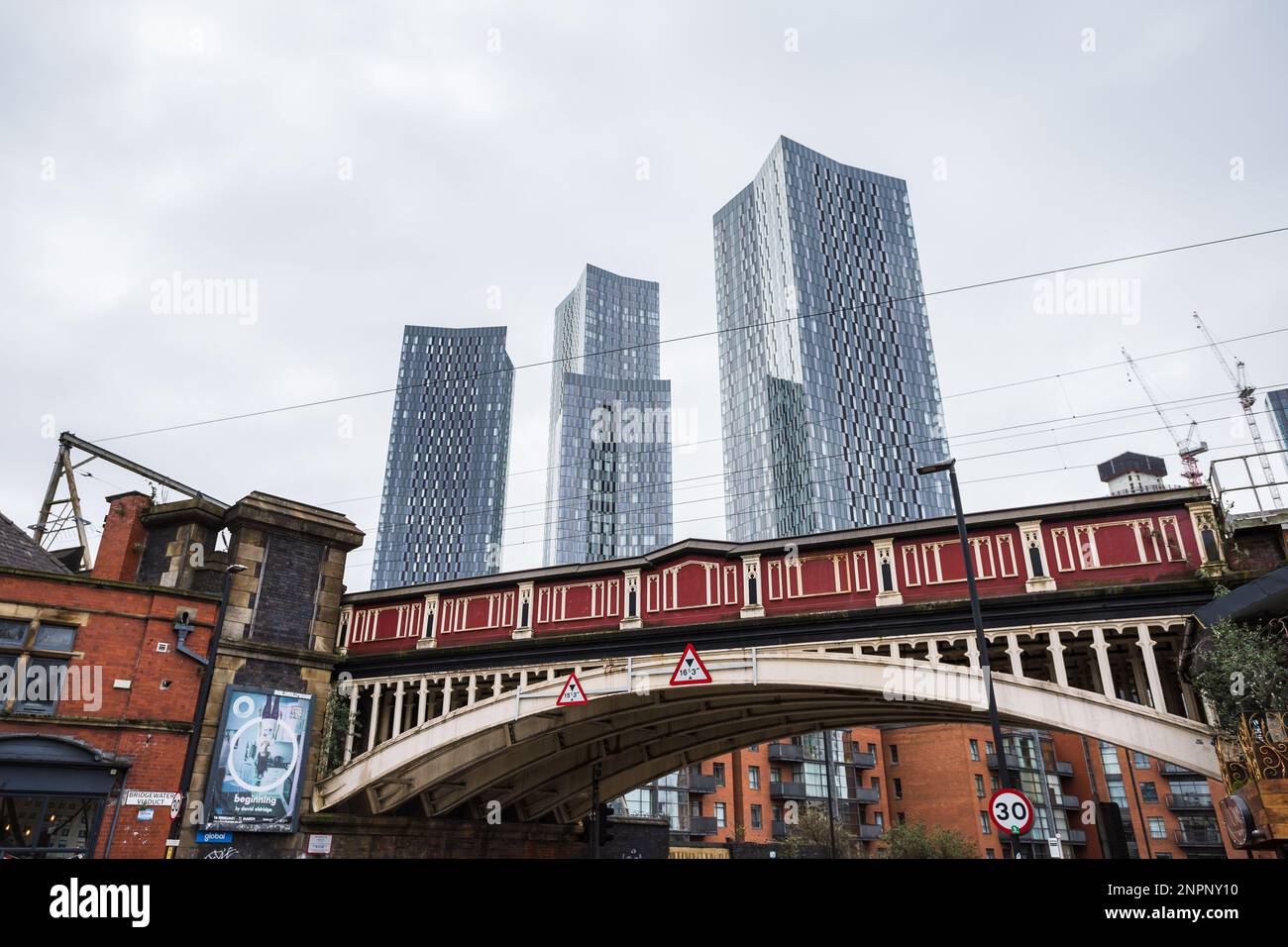 The Deansgate Square skyscrapers pictured above an red railway bridge