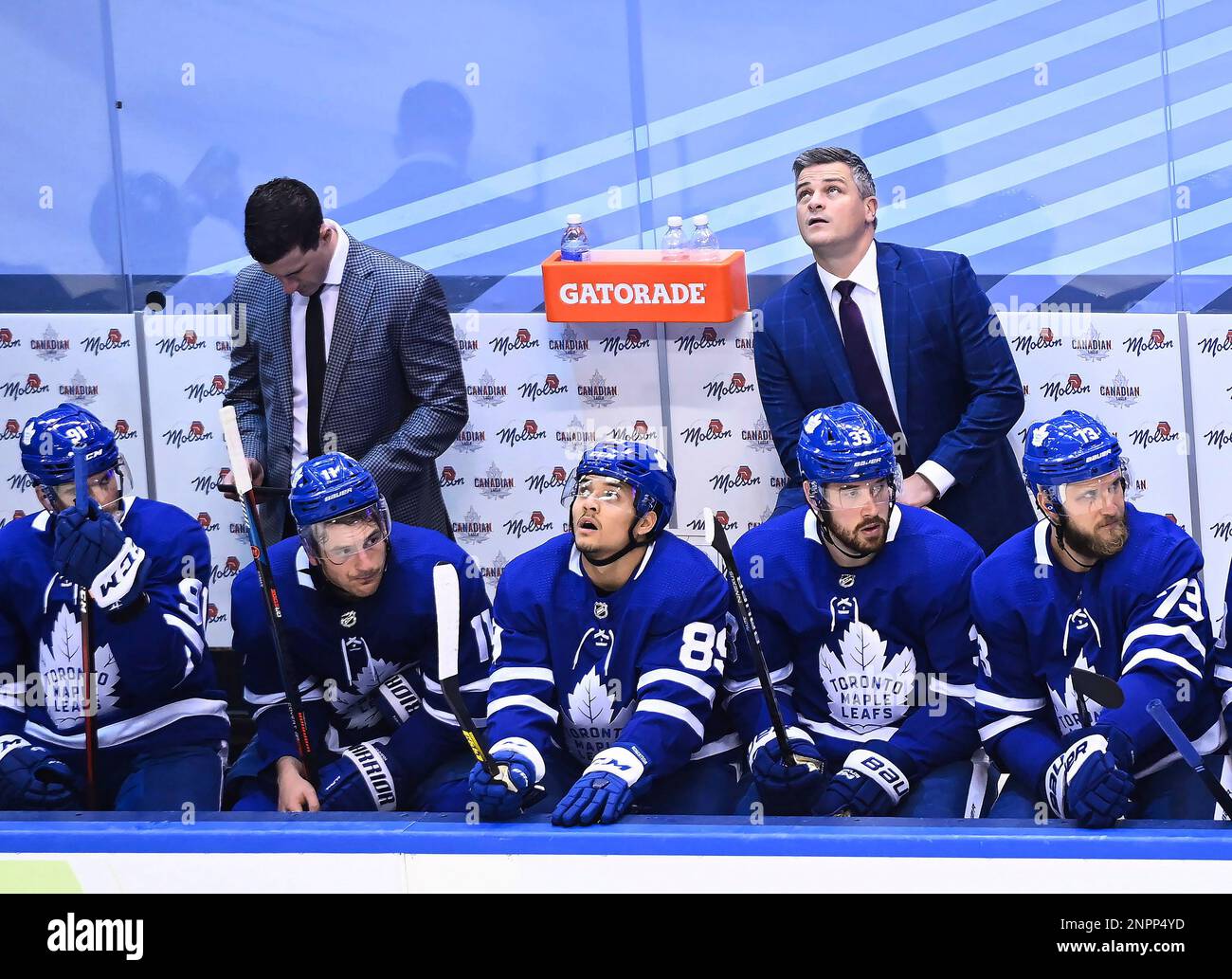 Toronto Maple Leafs coach Sheldon Keefe, back right, looks at the scoreboard in the final seconds of the teams NHL hockey playoff game against the Columbus Blue Jackets in Toronto, Sunday, Aug.