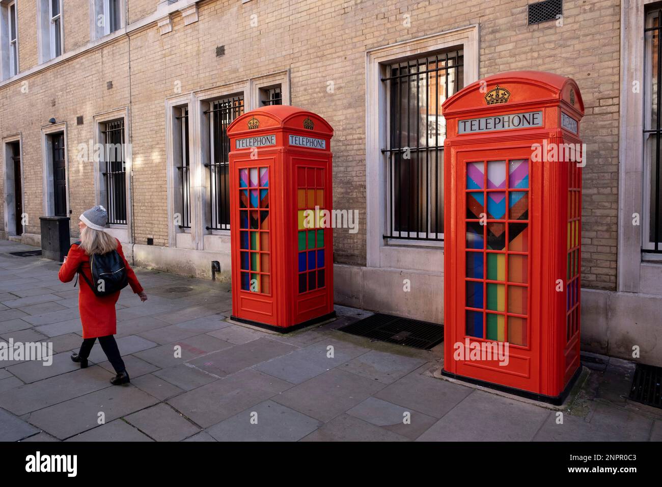 Pride Progress flags decorate the interior of red telephone boxes in Covent Garden on 7th February 2023 in London, United Kingdom. The flag includes the rainbow flag stripes to represent LGBTQ+ communities, with colors from the Transgender Pride Flag and to also represent people of colour. Stock Photo