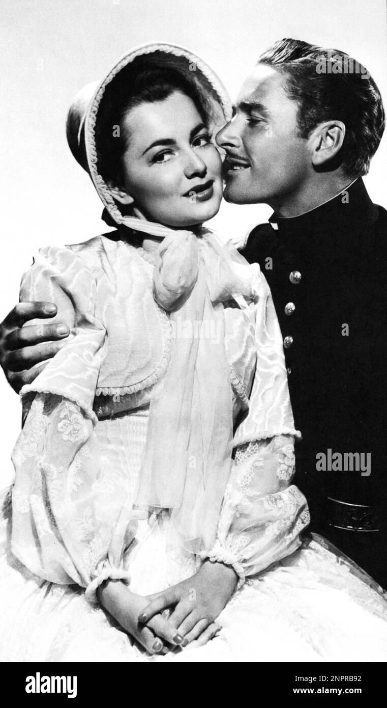 1940 : The movie actor ERROL FLYNN  ( Hobart 1909 - Vancouver , Canada 1959 ) with OLIVIA DE HAVILLAND ( born in Tokyo , Japan 1916 ) in SANTA FE TRAIL by Michael Curtiz  - CINEMA - FILM  - portrait - ritratto - baffi - moustache  - WESTERN - hero - eroe - WESTERN - profilo - profile - hat - cappello - embrace - abbraccio - kiss - bacio - lovers - innamorati - military uniform - uniforme divisa militare ----  Archivio GBB Stock Photo