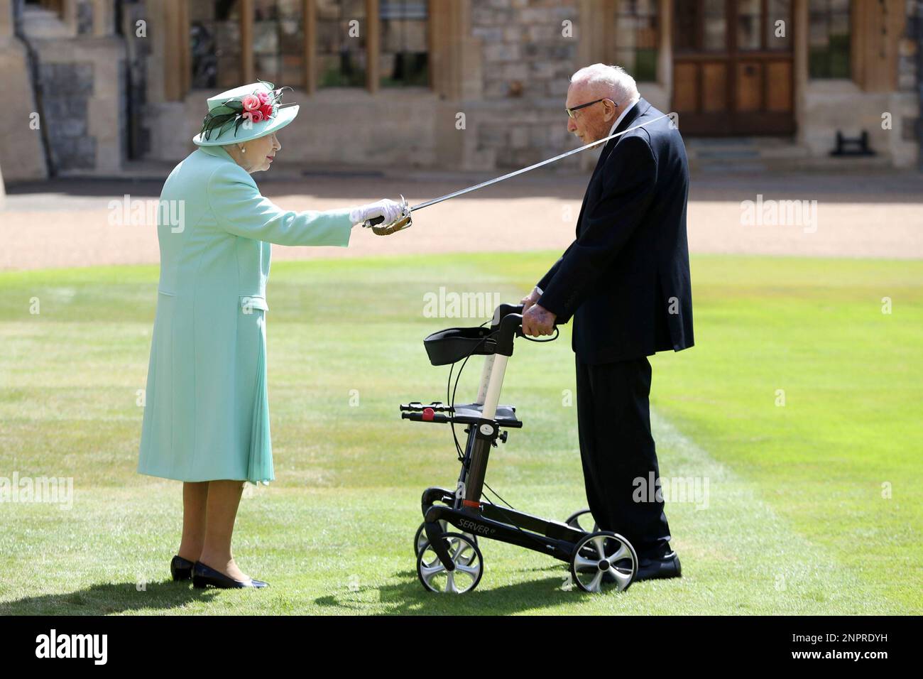 Capt. Sir Thomas Moore receives his knighthood from Britain's Queen