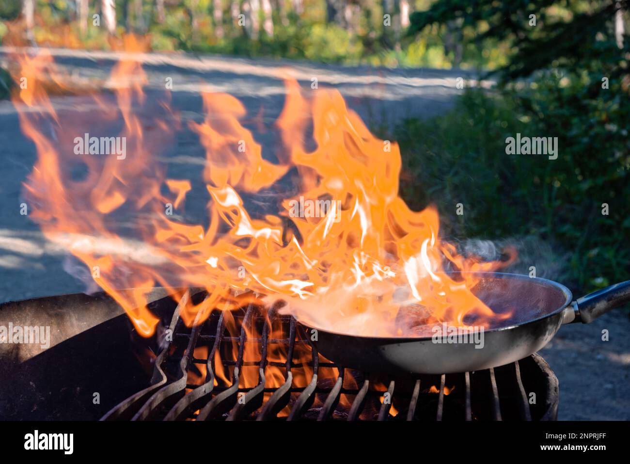 Campfire in summer. Cooking while camping outdoors in Canada