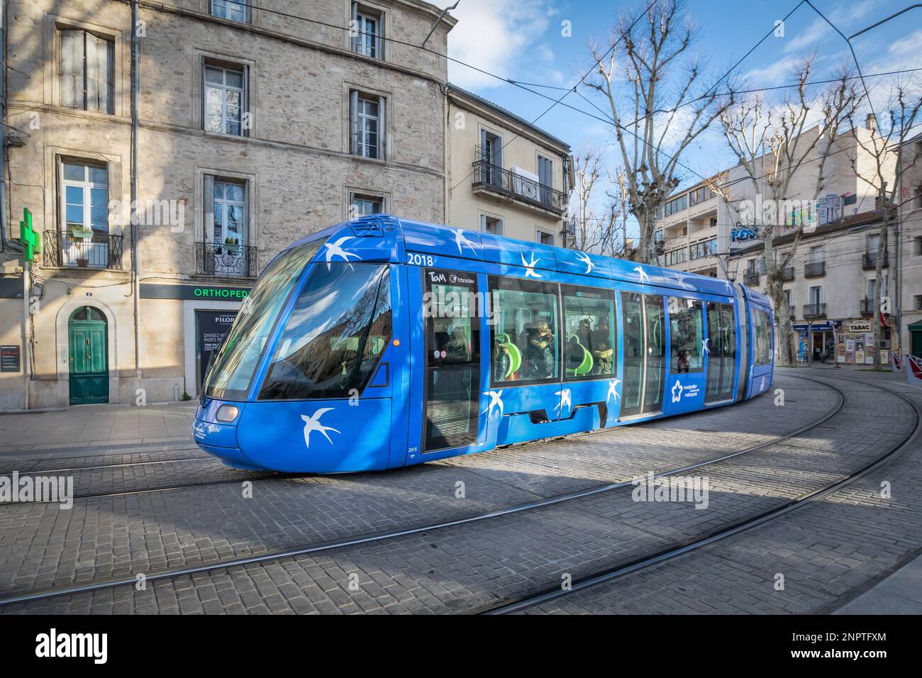 Montpellier, France - January 16 2018: Blue modern tram on the street of the city Stock Photo
