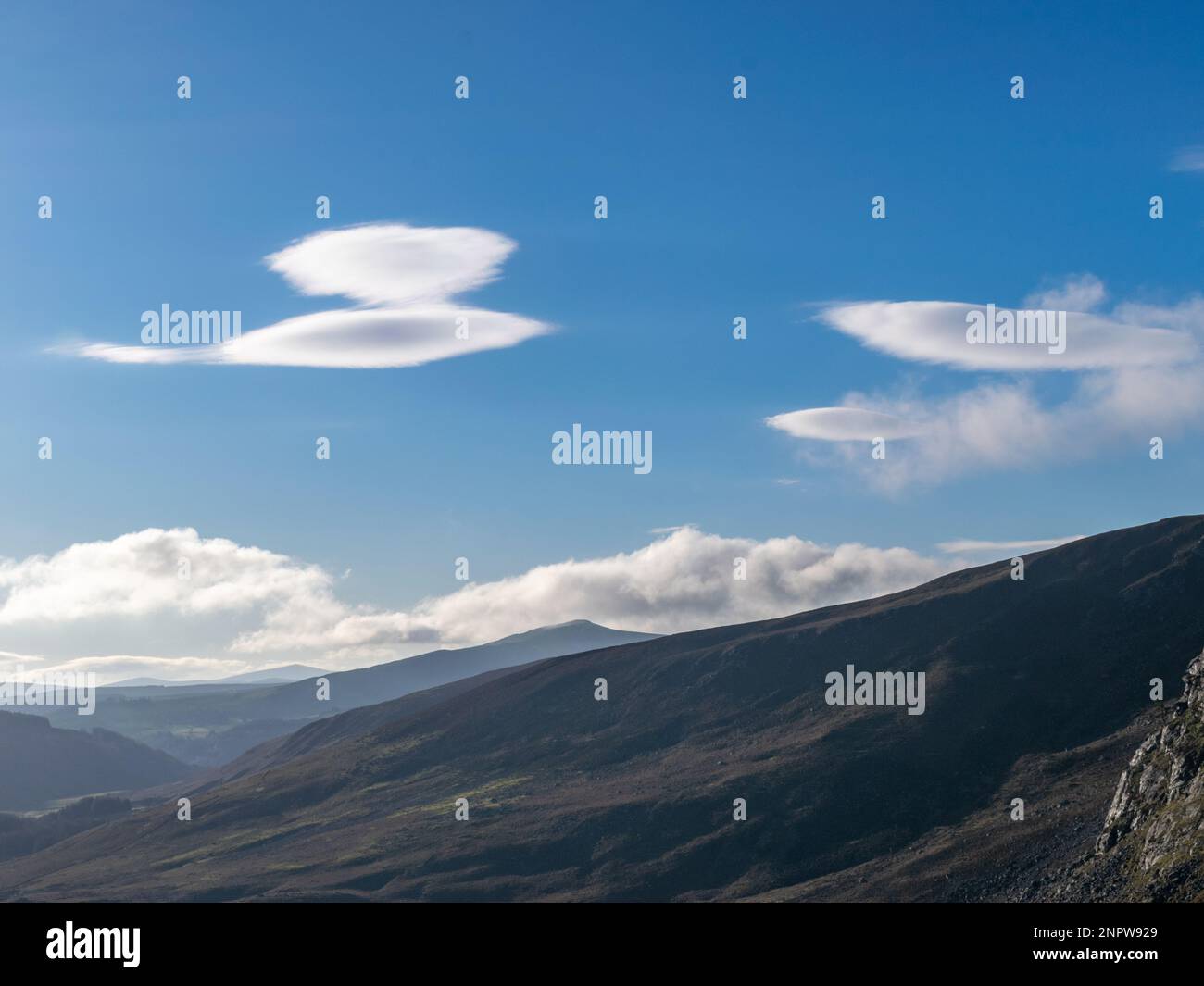 Lenticular clouds over Wicklow Mountains. Stock Photo