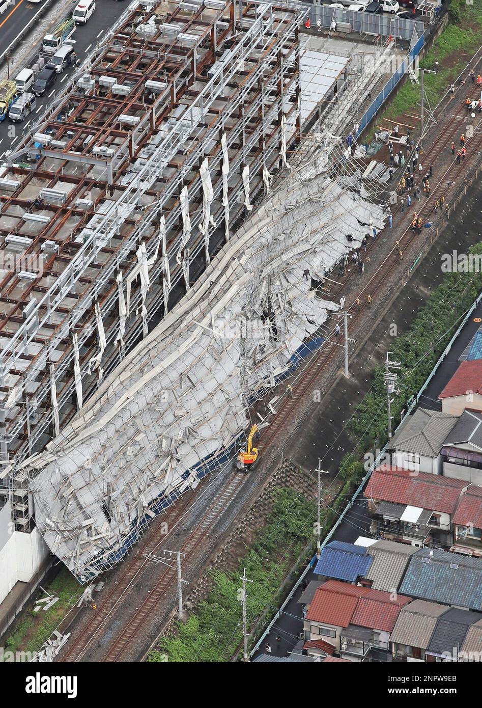 An aerial photo shows scaffolds being collapsed at the construction