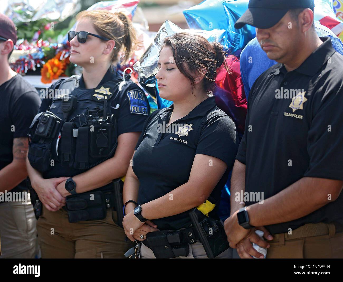 Tulsa Police Officer Nereyda Villa, center, reacts during a news