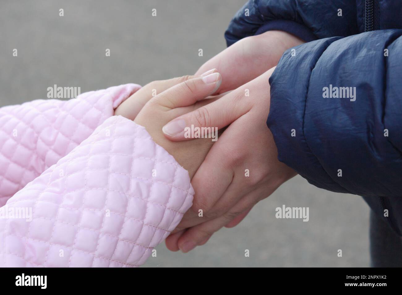 Two children hold each other's hands close-up. Stock Photo