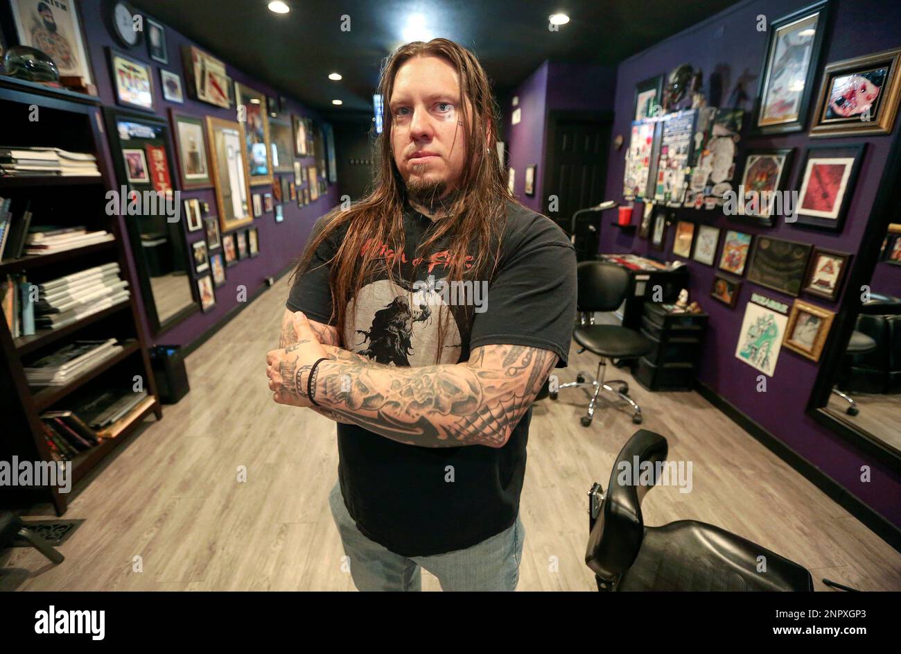 Greg Howell, owner of Dubuque Tattoo Club, poses in Dubuque, Iowa on