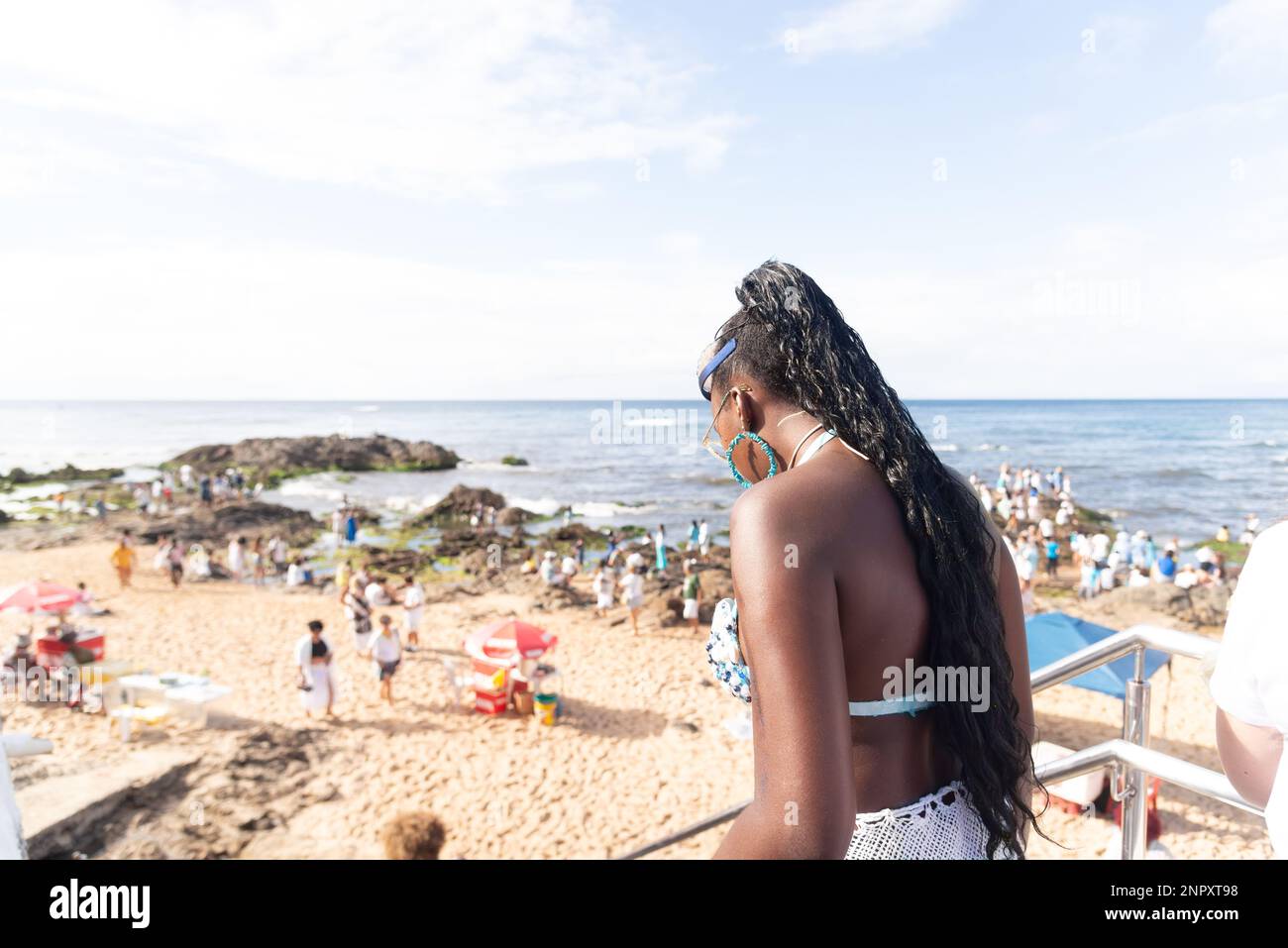 Salvador, Bahia, Brazil - February 02, 2023: Many people are on the beach of Rio Vermelho, offering gifts for the Yemanja party, in Salvador, Bahia. Stock Photo