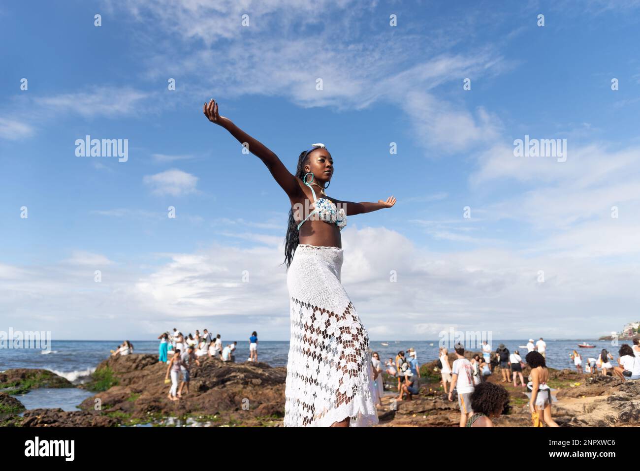 Salvador, Bahia, Brazil - February 02, 2023: Candomble people are on the rocks of Rio Vermelho beach, offering gifts to Yemanja. Salvador, Bahia. Stock Photo