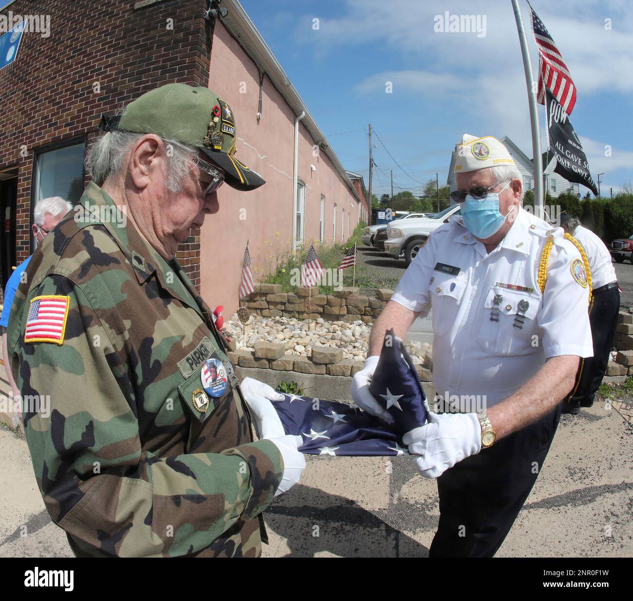 Charles Parker, Sr., and William Hines fold a flag which was donated to ...