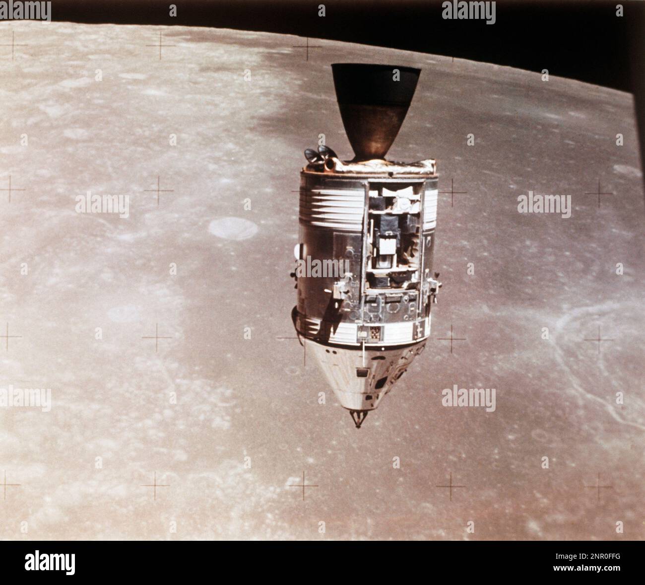 This August 1971 photo made available by NASA shows the Apollo 15 command and service modules in lunar orbit seen from the lunar module, with the lunar surface below. (NASA via AP) Stock Photo