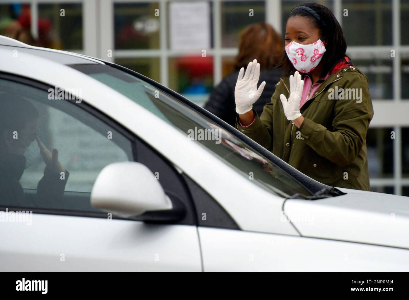 In this Tuesday, May 19, 2020 photo, teacher Ciara Jackson waves