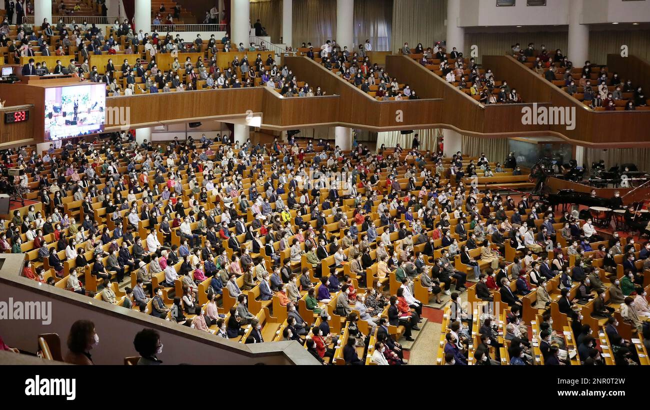 Christians attend a service while maintaining social distancing at the