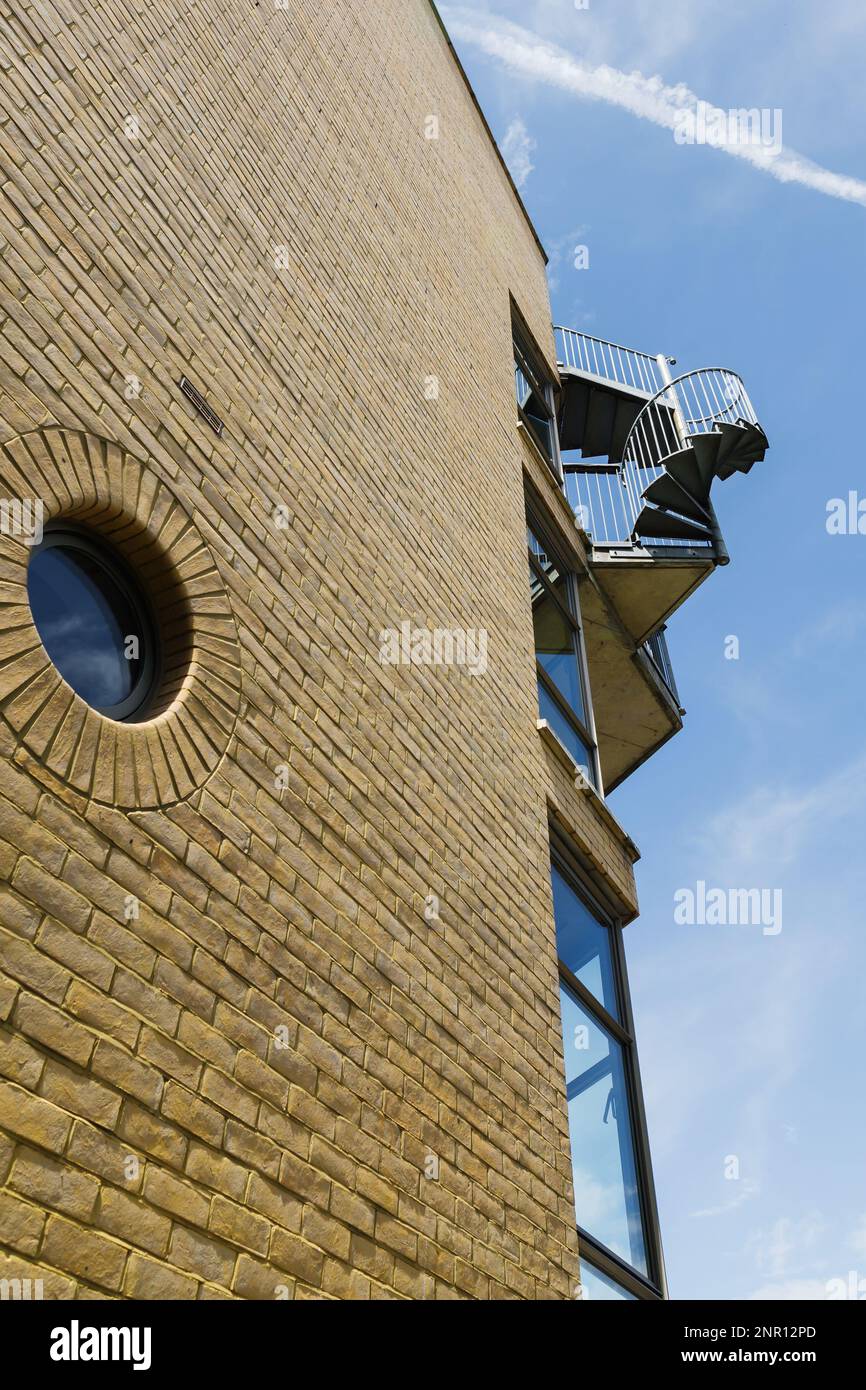 picture of a building with an outdoor spiral case at the corner