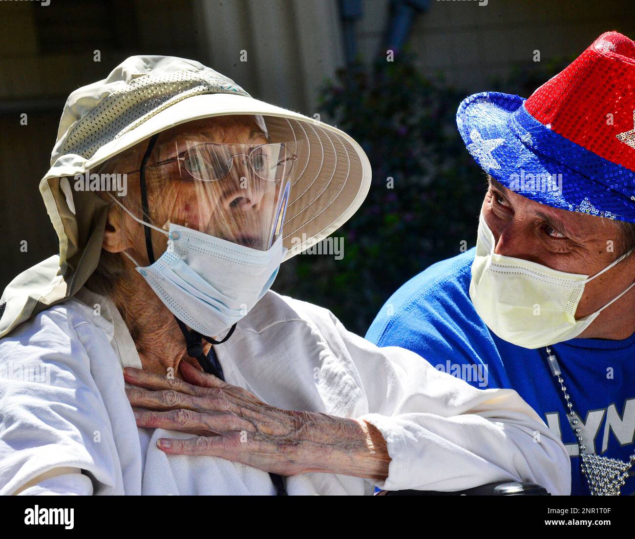 Jane Reed reacts when she sees her family during a parade as Reggie