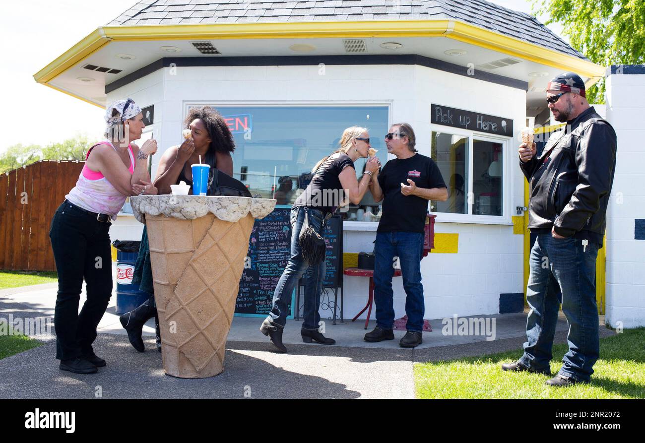 People eat ice cream in front of King's Scoop on Saturday, May 9, 2020 in Selah, Wash. Selah