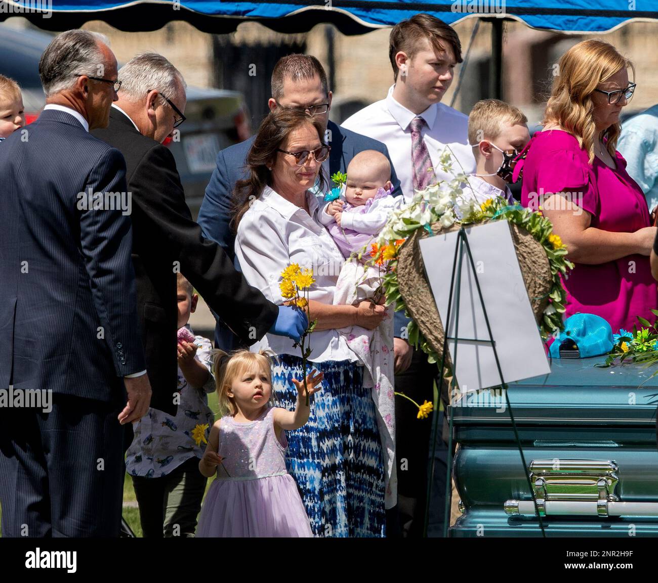Marshall Crane, father of Katherine Butterfield, hands his