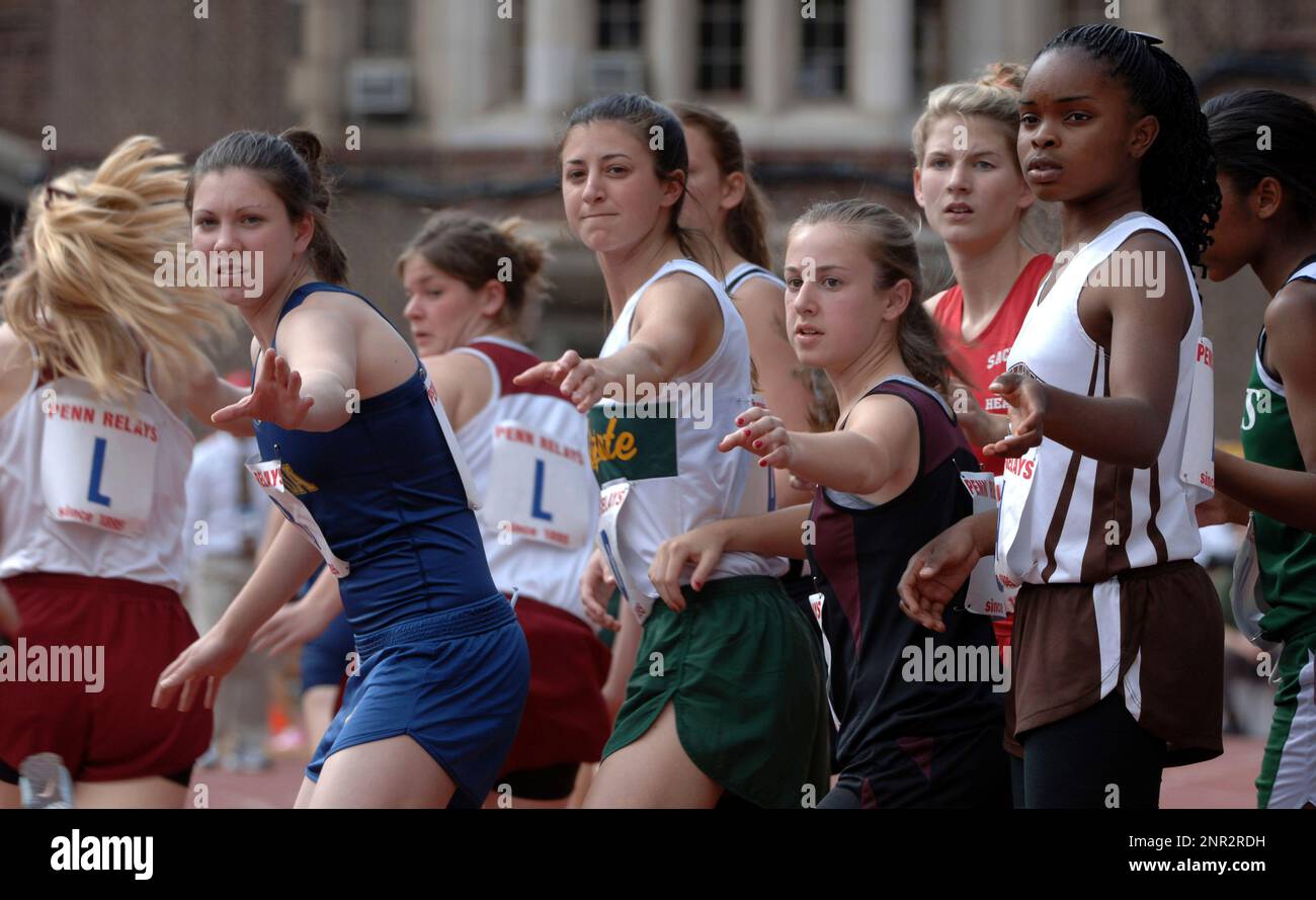 Runners await a handoff during the high school girls 4 x 400 meter
