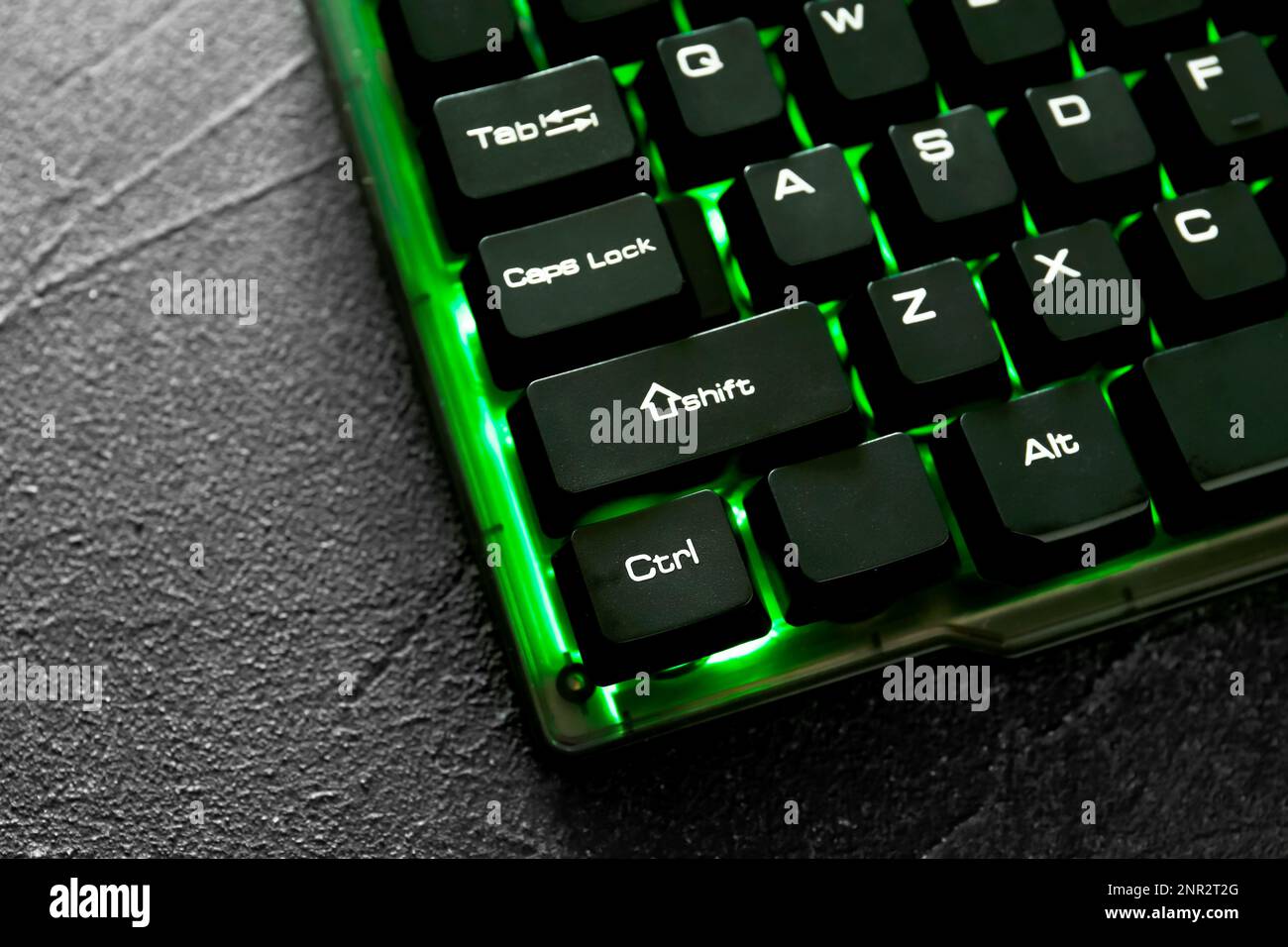 Modern keyboard with RGB lighting on grey table, closeup Stock Photo