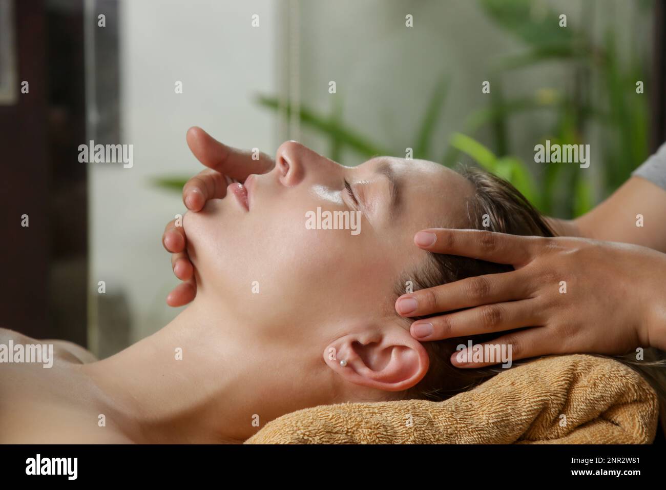 Face massage, a woman in the spa having anti-age face massage Stock Photo