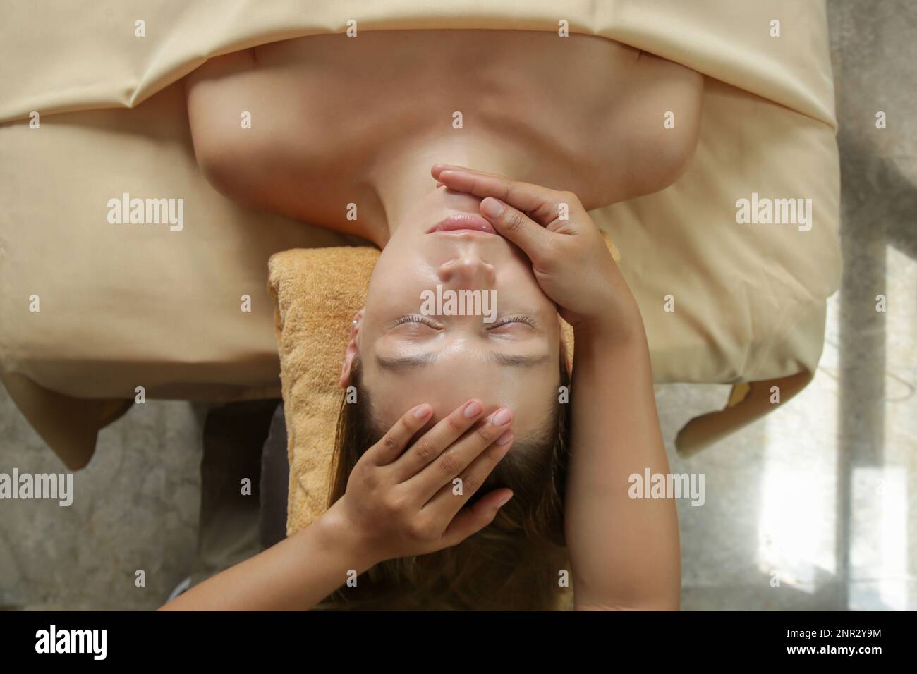 Face massage, a woman in the spa having anti-age face massage Stock Photo