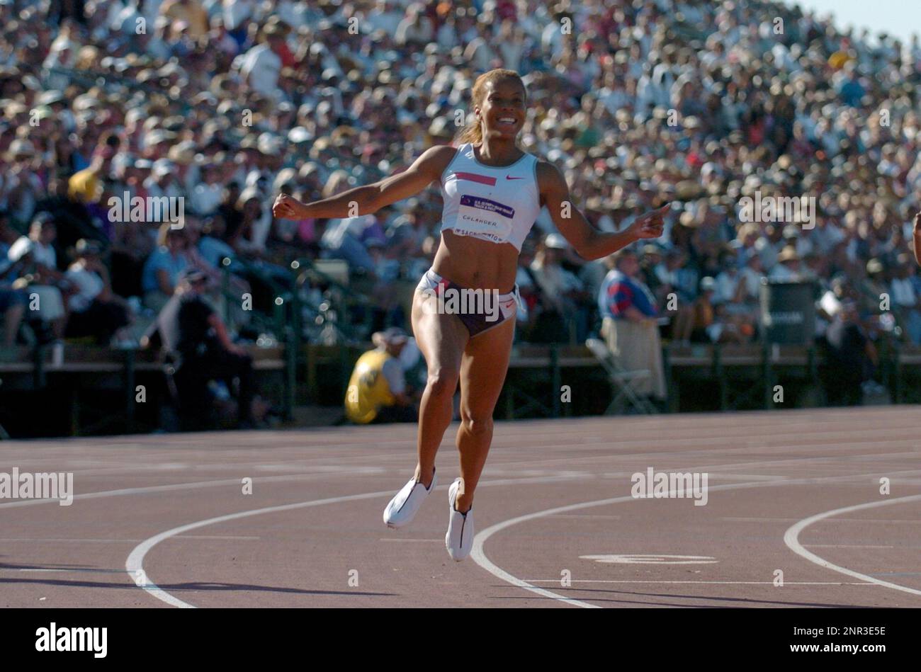 LaTasha Colander celebrates after winning the women's 100 meters in 10.