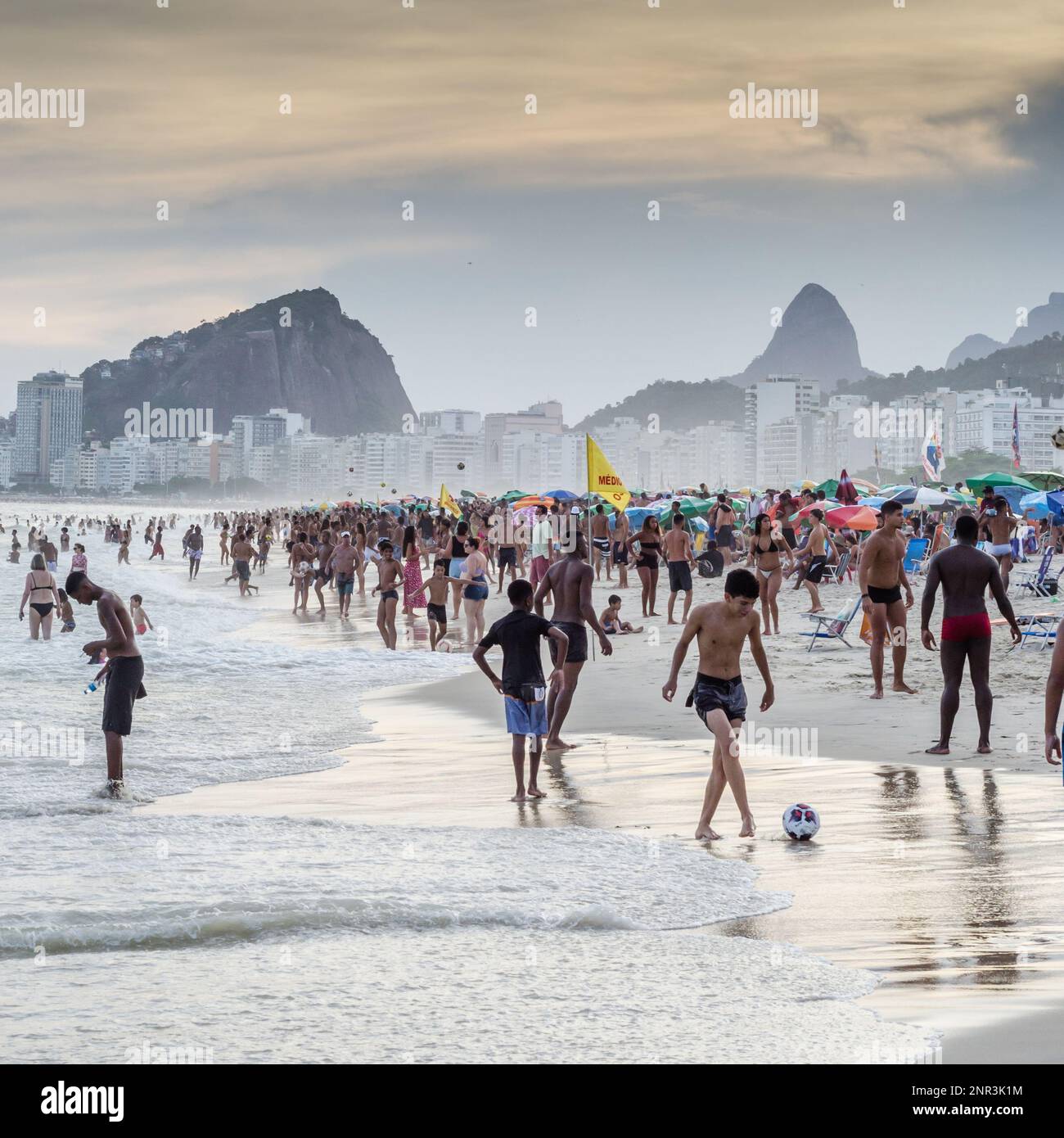Crowded Copacabana Beach in Rio de Janeiro, Brazil at sunset Stock Photo