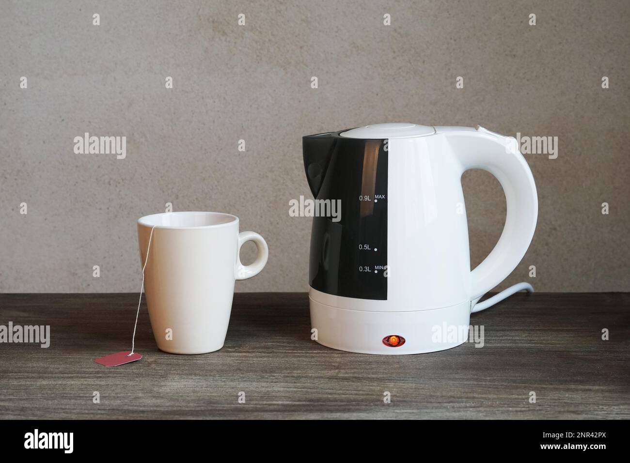 tea making facilities with electric water kettle, teacup and teabag Stock Photo Alamy