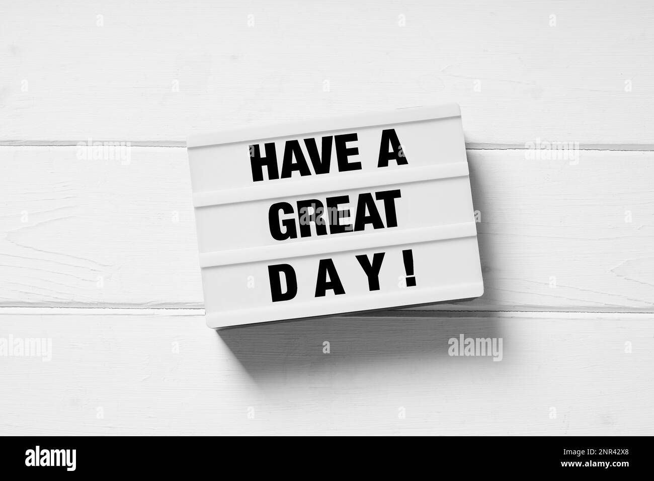 have a great day motivational text on light box light box sign on white wooden background Stock Photo