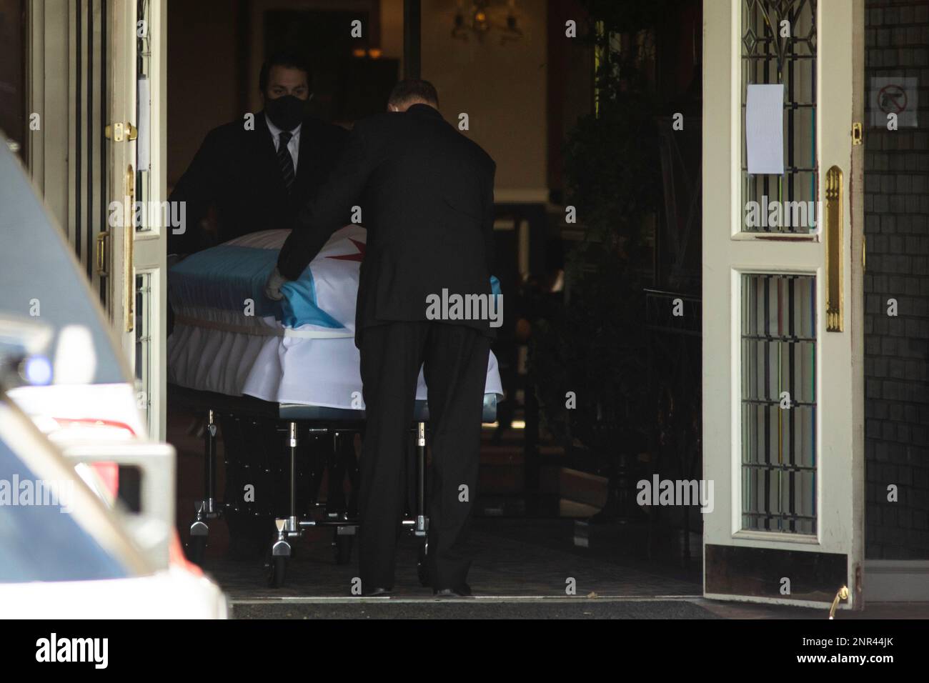 Funeral workers carry the casket to the hearse for Chicago Police