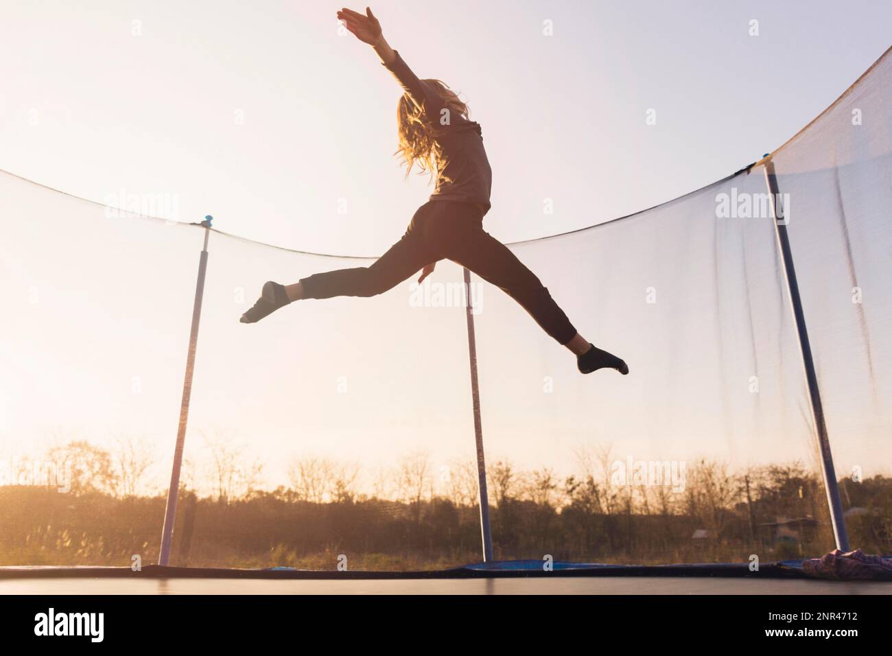 Happy girl jumping blue sky hi-res stock photography and images - Alamy