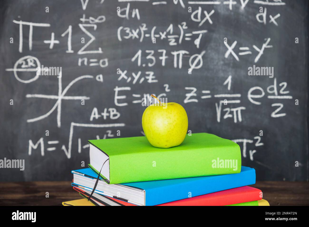 apple books pile near chalkboard. High resolution photo Stock Photo Alamy