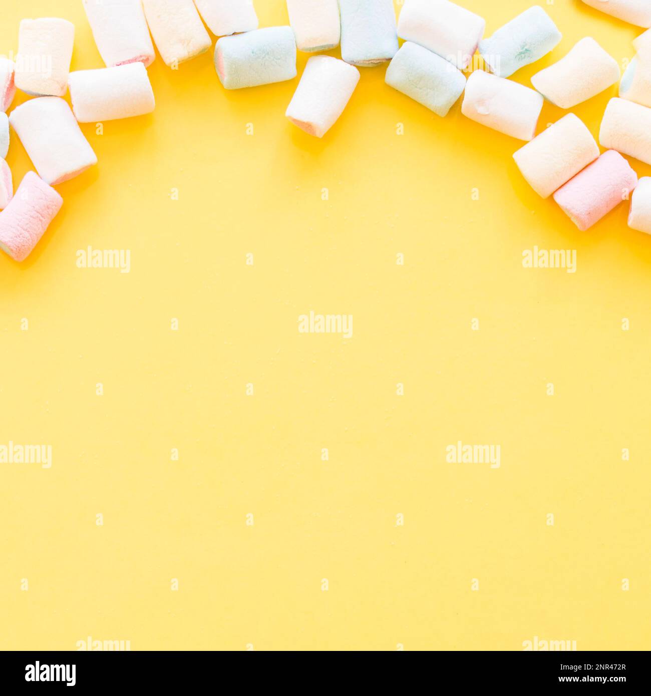 soft marshmallows edge yellow background. High resolution photo Stock