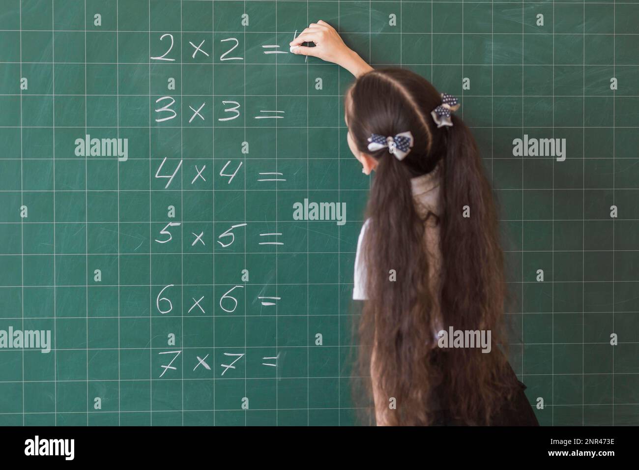 girl making calculations blackboard. High resolution photo Stock Photo