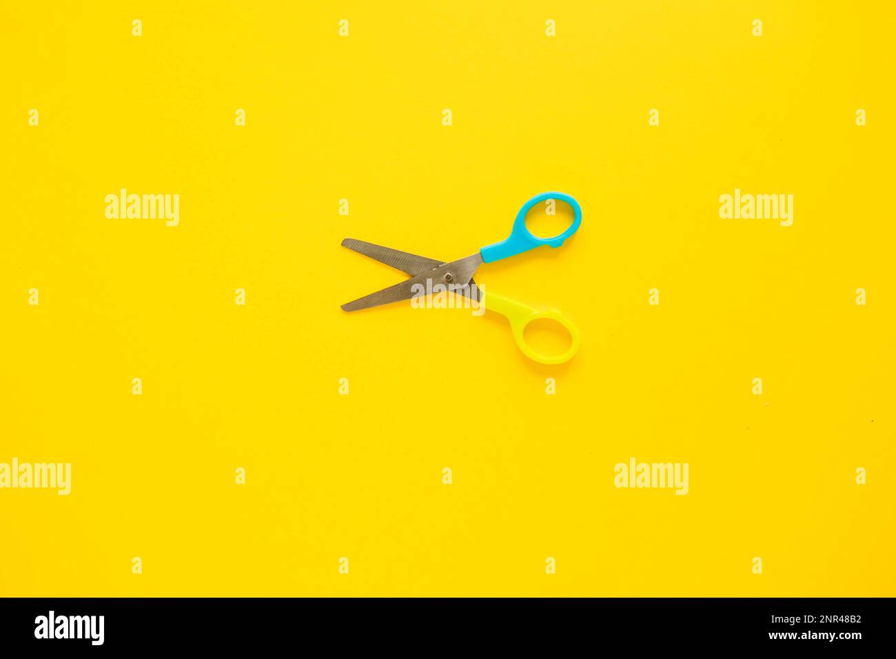 opened scissors laid middle Stock Photo