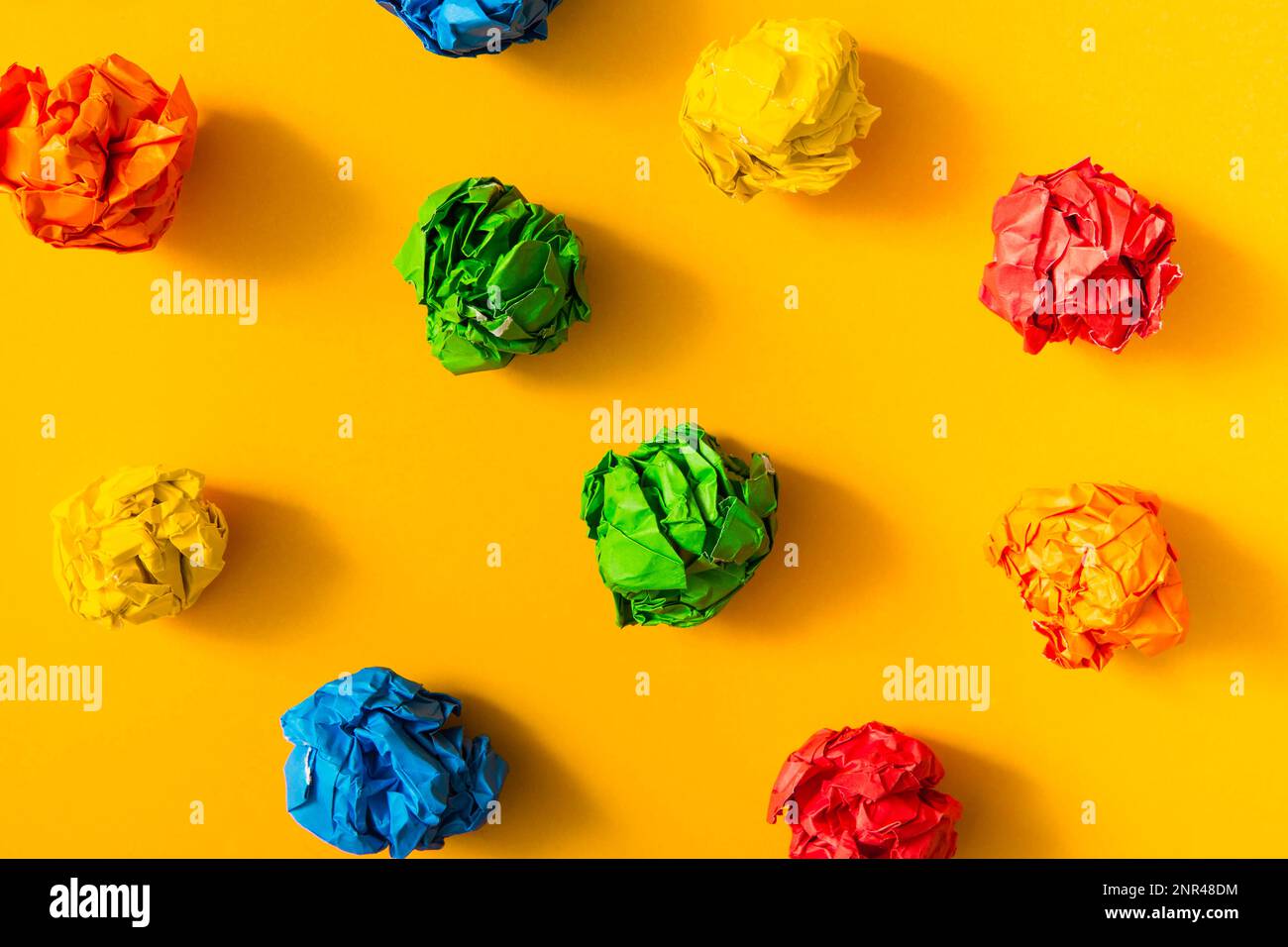 Colorful crumpled paper ball yellow background Stock Photo Alamy