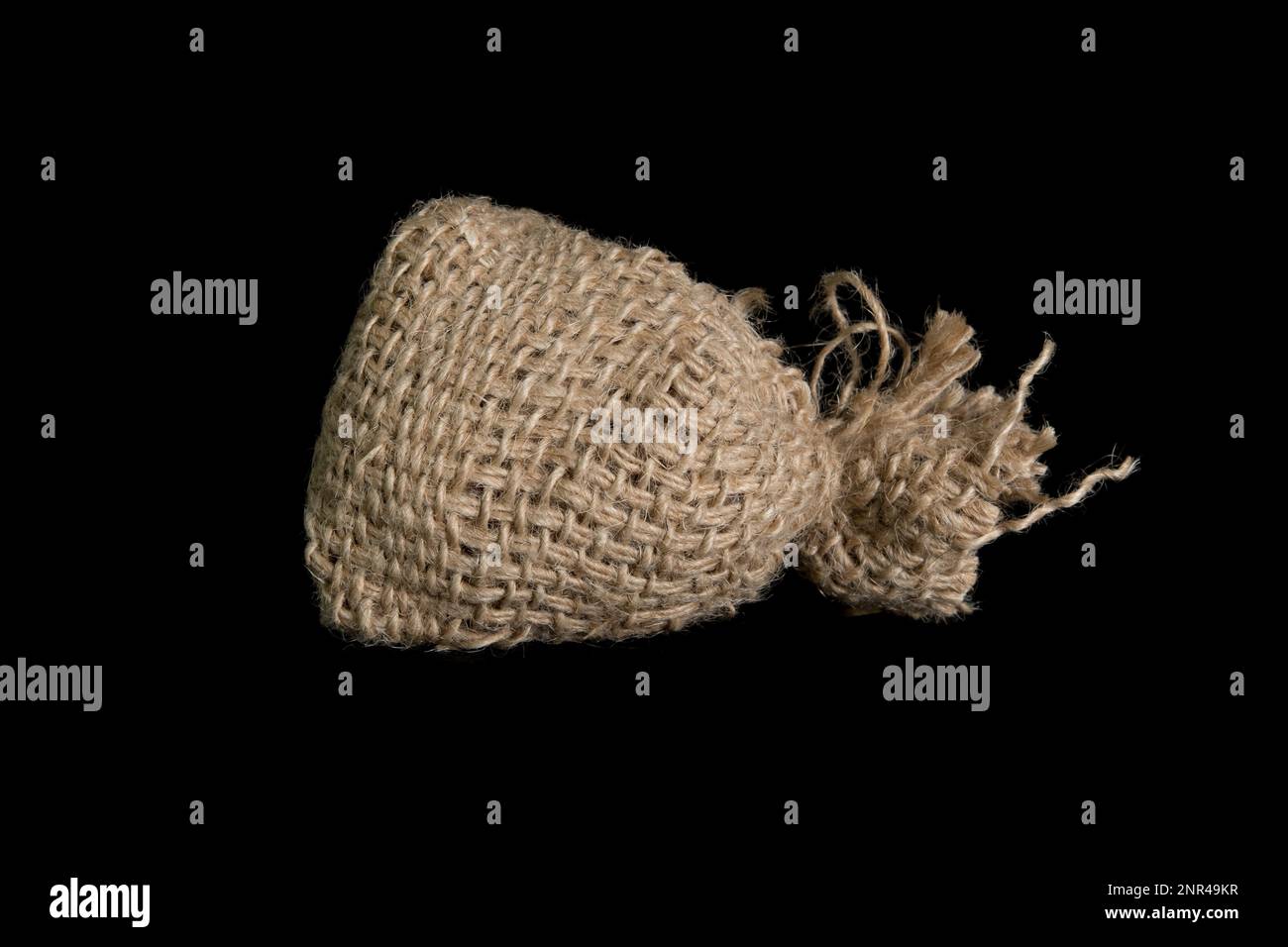 A small jute bag on a black background. In studio Stock Photo