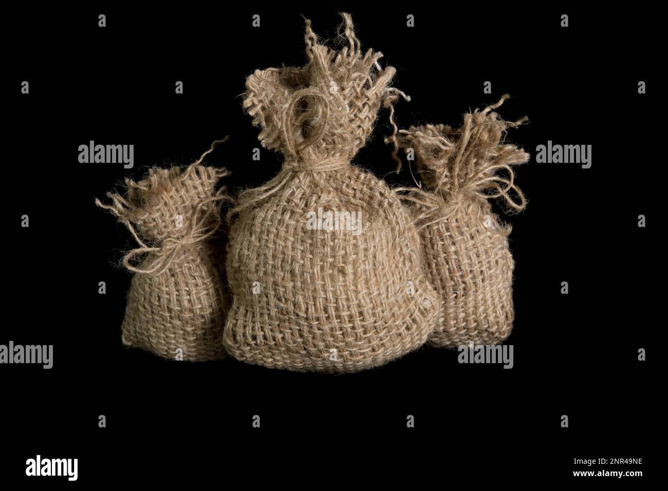 A small jute bag on a black background. In studio Stock Photo