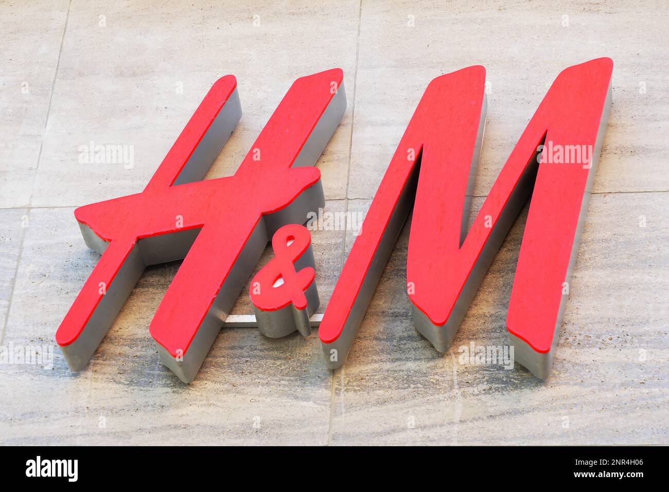 Hannover, Germany - May 8, 2018: H&M logo sign on facade of local fashion chain store of global multinational retail company Hennes and Mauritz Stock Photo