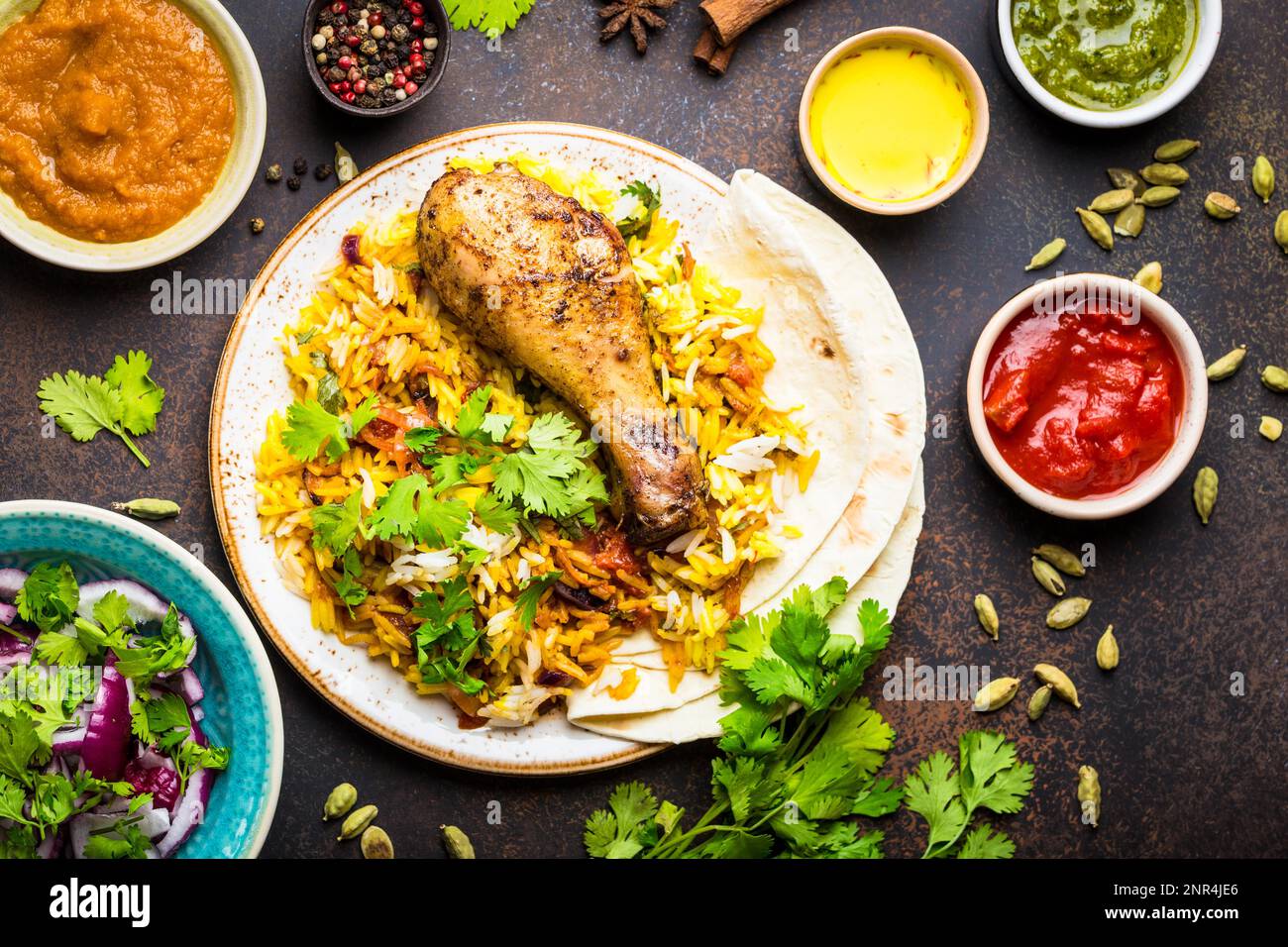 Closeup of assorted traditional Indian dishes, top view of biryani