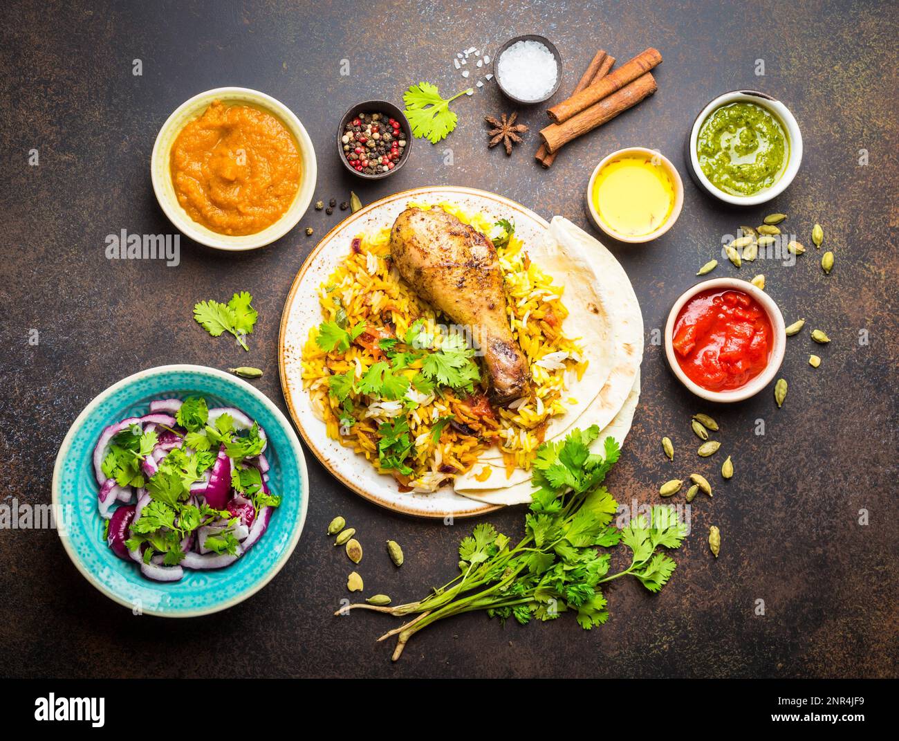 Assorted traditional Indian dishes, a top view of biryani chicken with